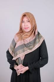 Portrait of a smiling Indonesian woman with short hair and glasses